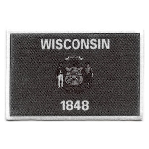 May include: A black and white embroidered patch with the word "WISCONSIN" in white lettering, a state seal, and the year "1848" in white lettering.