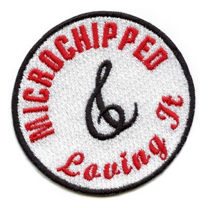 May include: White round embroidered patch with red text that says "Microchipped & Leaving It" and a black treble clef symbol.