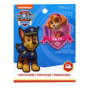 May include: Two iron-on patches featuring characters from the Nickelodeon show Paw Patrol. The patches are on a blue and yellow background with the words "Paw Patrol" and "Simplicity". The patches are of Chase and Skye, with the text "Skye" on the pink patch.
