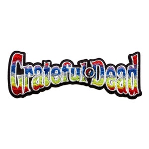 May include: Embroidered patch featuring the words "Grateful Dead" in a rainbow of colors, outlined in black. The iconic Steal Your Face skull and lightning bolt logo is in the center. A vibrant accessory for jackets, bags, or other fabric items.