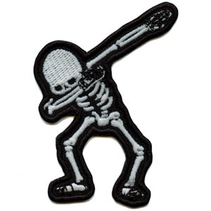 May include: White skeleton figure in a dabbing pose, embroidered on a black patch.