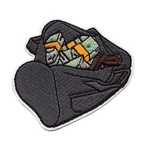 May include: A black duffel bag embroidered with green and yellow cash and a brown gun inside.