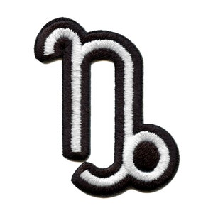 May include: Black and white embroidered iron-on patch of the astrological sign Capricorn.