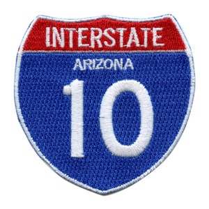 May include: Blue and red Interstate 10 highway sign patch with white lettering. The sign says "Interstate" and "Arizona" and the number "10" in white.