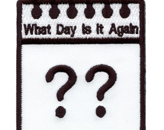 May include: White calendar patch with brown stitching. The calendar says "What Day Is It Again?" with two question marks in the date space.