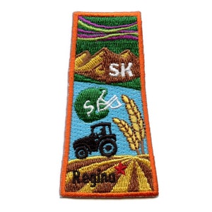 May include: An embroidered patch with a tractor, wheat, a football, and mountains. The patch is orange, brown, green, blue, and white. It says "Regina" and "SK" on it.