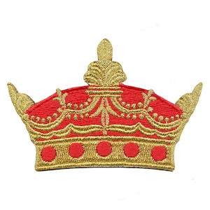 May include: A red and gold embroidered crown patch. The crown has a pointed top and a rounded base with five gold circles.