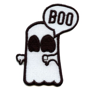 May include: A white ghost with black eyes and a mouth saying "BOO" in a speech bubble. The ghost is outlined in black and has a textured fabric appearance.
