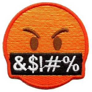 May include: Orange and black embroidered patch with a yellow smiley face with angry eyebrows and a black bar over the mouth with the text "& $! # %" in white.
