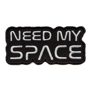 May include: Black embroidered patch with white text that reads "NEED MY SPACE".