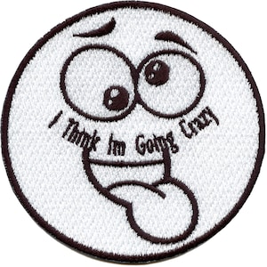 May include: White embroidered patch with a cartoon face with big eyes and a tongue sticking out. The text "I Think I'm Going Crazy" is written around the face.