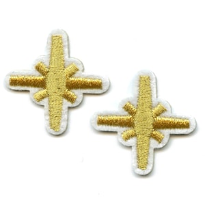 May include: Two gold embroidered iron cross patches with white backing.