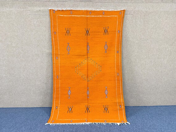Orange flat weave rug 7.6 x 5 ft