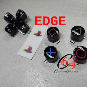May include: Set of six black PlayStation controller buttons with different coloured symbols. The symbols are a triangle, circle, cross, square, and two PlayStation logos. The buttons are labelled "EDGE".