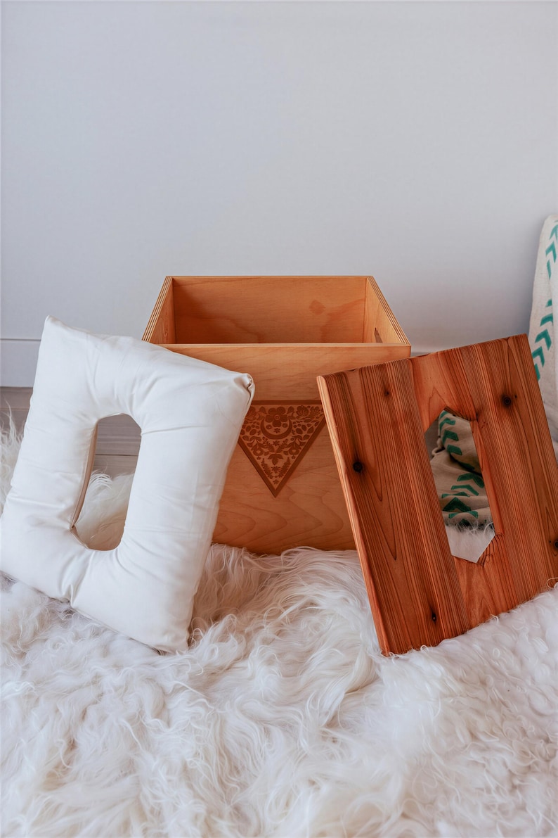 a wooden box with a cutout on the lid, placed on a white shag rug.