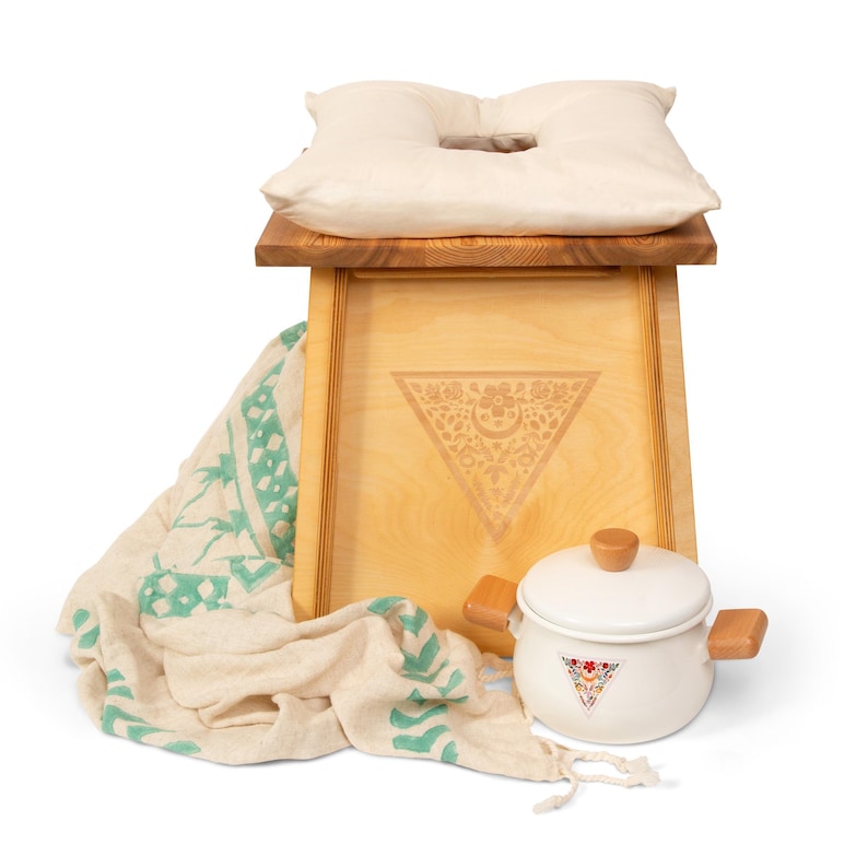 a wooden box with a pillow and a tea pot