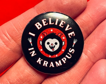 May include: A black button with the text "I BELIEVE IN KRAMPUS" in white. The button features a cartoon Krampus character with a red circle border and white accents. The background is red.