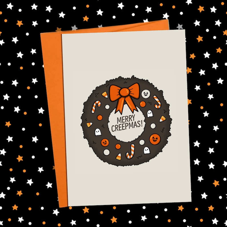 May include: A Halloween-themed greeting card with an orange envelope. The card features a black wreath with candy corn, candy canes, and ghost and jack-o'-lantern illustrations. The text "MERRY CREEPMAS!" is in the center of the wreath.