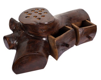 May include: A wooden box carved to resemble a tree trunk with two drawers and a small compartment on top. The box is dark brown and has a natural wood finish.