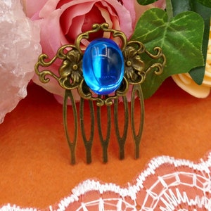 small bronze hair comb with blue glass cabochon