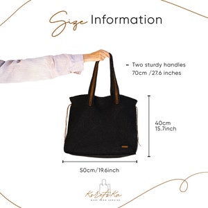 May include: Black tote bag with brown leather handles and a black and white woven design. The bag measures 19.6 inches wide, 15.7 inches tall, and has handles that are 27.6 inches long. The bag is made in Ukraine.