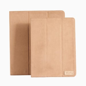 May include: Two beige tablet cases with a stitched edge. The case on the right has a small logo that says "Kuffa".