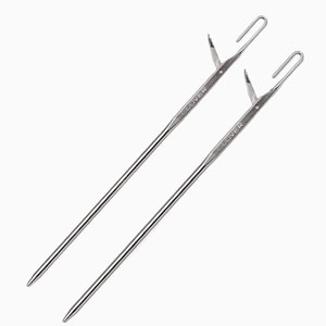 May include: Two silver Clover brand yarn needles with a hook at the end.