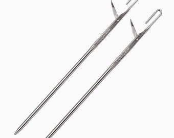 May include: Two silver Clover brand yarn needles with a hook at the end.