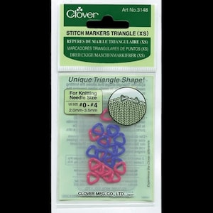 Puede incluir: Un paquete de marcadores de punto triangulares Clover (XS). El paquete contiene marcadores de punto rosas y azules en forma de triángulo. El paquete también incluye texto que dice "Unique Triangle Shape!" y "For Knitting Needle Size US SIZE #0-#4 2.0mm-3.5mm."