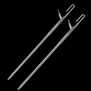 May include: Two silver Clover brand crochet hooks against a black background. Each hook has a long, slender shaft, a hook at one end, and a pointed tip at the other. The word "CLOVER" is printed on the shaft of each hook.
