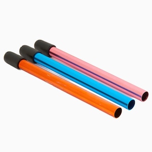 May include: Three metal tubes with black caps. The tubes are orange, blue and pink.
