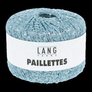 May include: A ball of light blue yarn with silver sequins. The yarn is wrapped with a white label that reads "LANG YARNS PAILLETTES". The yarn is a soft, textured material.