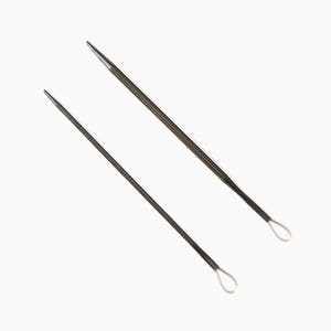 May include: Two silver threaders with loops at the ends. The threaders are used for threading beads and other small objects.