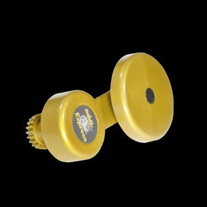 May include: A gold-colored, mechanical device with a circular component and a gear-like edge. The device has the text "addli-Express" on a circular label. The background is solid black.