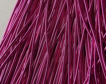 May include: A bundle of bright pink metallic cord, perfect for crafting jewelry or adding a pop of color to your projects.