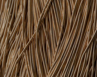 May include: A close-up of a bundle of gold elastic cord. The cord is made of a thin, flexible material and is perfect for crafting projects.