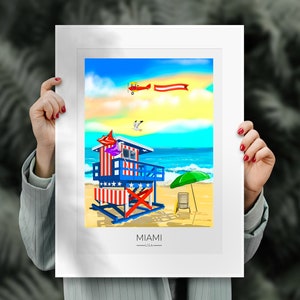 May include: A colorful illustration of a Miami beach scene. A lifeguard stand with red and white stripes and blue accents stands on a sandy beach. A biplane flies in the sky above the ocean. The word "MIAMI" is at the bottom.