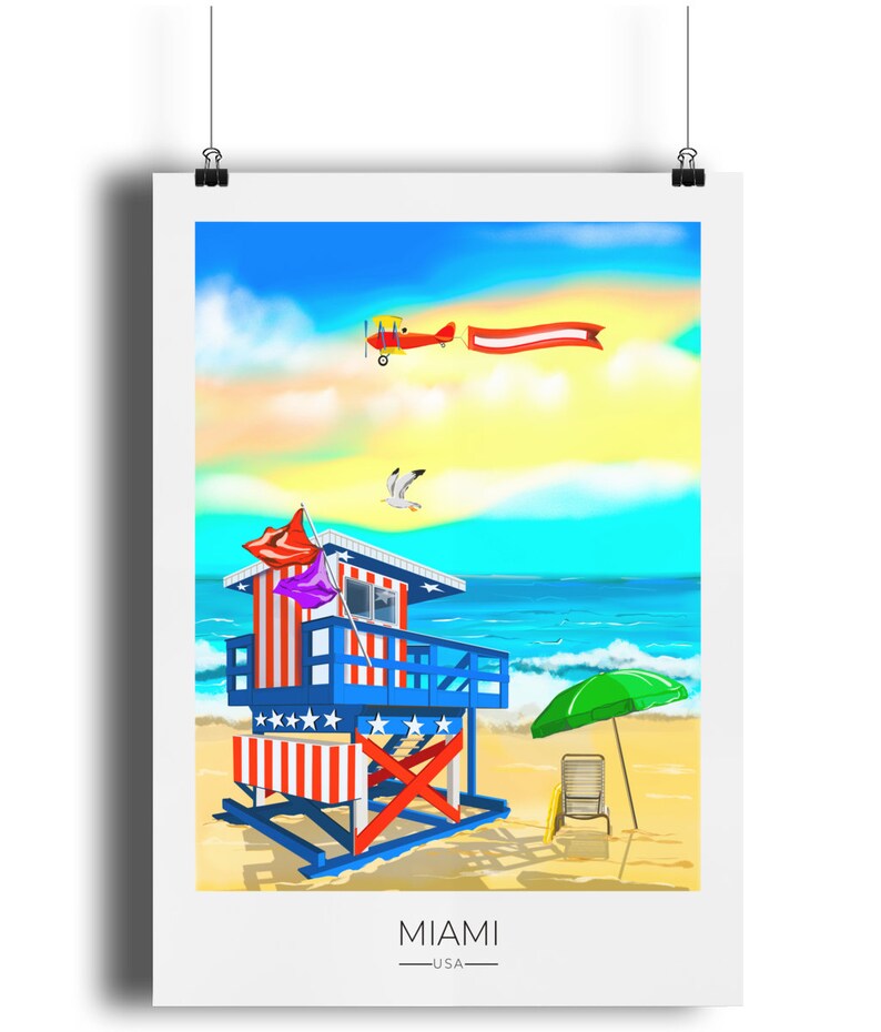 May include: A colorful Miami beach scene print. A lifeguard station with red, white, and blue stripes stands on a sandy beach. A red biplane pulls a banner across a blue sky. A green umbrella and beach chair are on the sand. The word "MIAMI" is at the bottom.