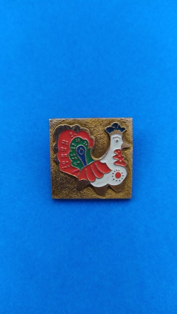 Soviet vintage pin made of metal and enamel made in the USSR in 1980. Icon Puppy with a ball