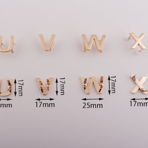 May include: Gold metal letters in the alphabet U, V, W, and X. The letters are approximately 1.5 inches tall and are on a white background.