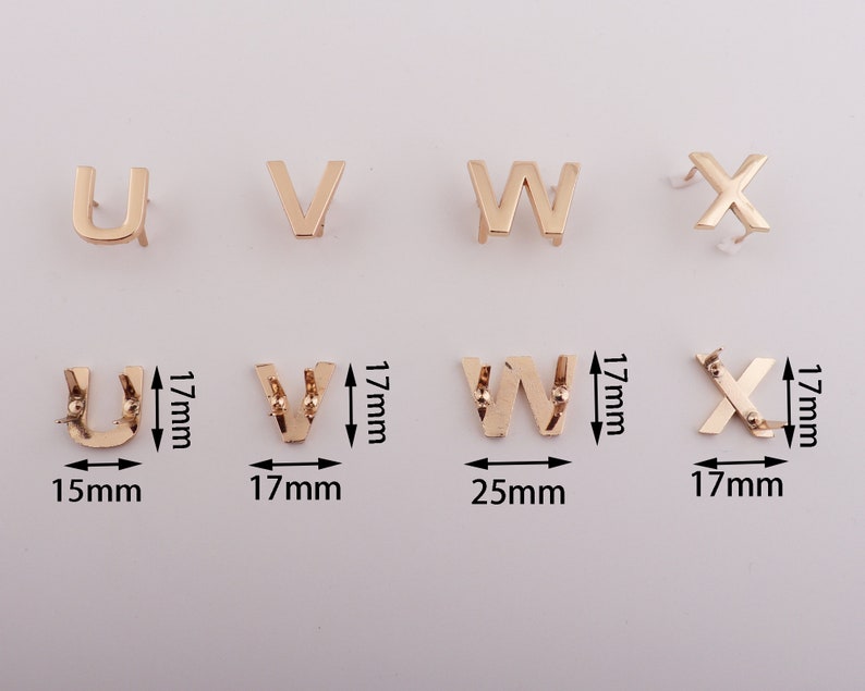 May include: Gold metal letters in the alphabet U, V, W, and X. The letters are approximately 1.5 inches tall and are on a white background.