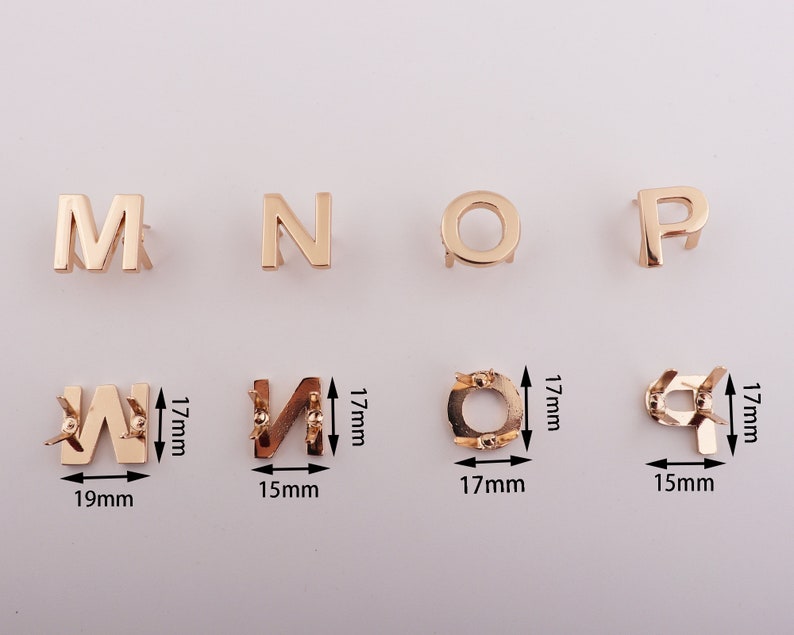 May include: Gold metal letters M, N, O, P, W, and a circle, each with a small hole at the top. The letters are approximately 1.5 inches tall and the circle is approximately 1.5 inches in diameter.