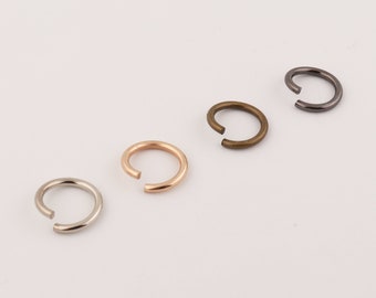 May include: Four jump rings in different metal finishes: silver, gold, rose gold, and black.