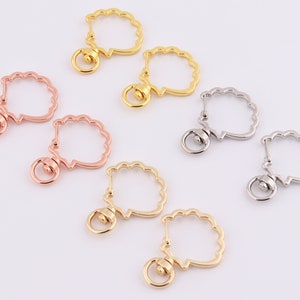 May include: Six gold, rose gold, and silver keychains with a scalloped design and a swivel clasp. The keychains are arranged in pairs on a white surface.