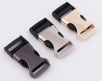 May include: Three plastic buckle closures in different finishes: silver, gold, and black. The buckles are designed for use with webbing or straps.