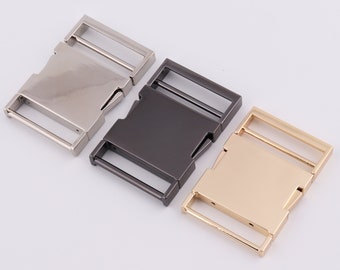 May include: Three metal buckle closures in silver, black, and gold. The buckles are designed for use with straps or belts.