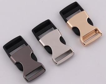 May include: Three plastic side release buckles in different metal finishes: silver, gold, and black.