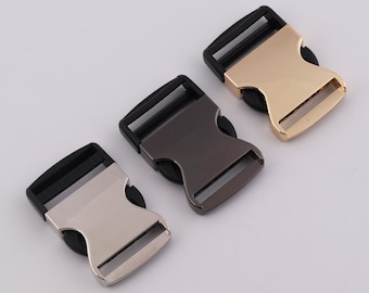 May include: Three plastic side release buckles in different finishes: silver, black, and gold. The buckles are designed for use with webbing or straps.