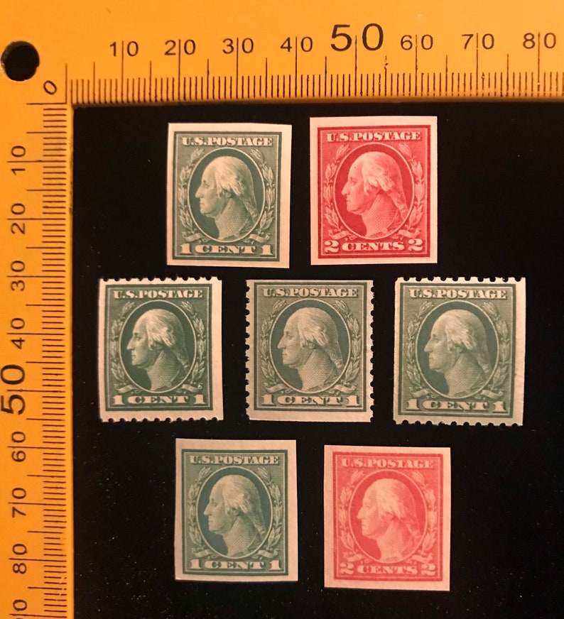 May include: A collection of six vintage US postage stamps featuring a profile of George Washington. The stamps are in various shades of green and red, with denominations of 1 cent and 2 cents.