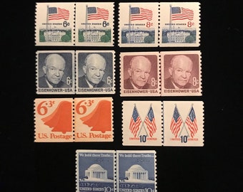 May include: A collection of vintage United States postage stamps featuring various designs, including the White House, a bell, flags, and a portrait of President Eisenhower. The stamps are in various denominations, including 6 cents, 8 cents, 10 cents, and 6 3/10 cents.